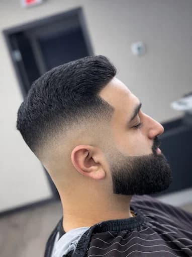 Short taper fade with a shaped full beard