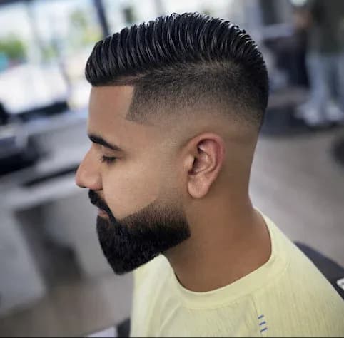 Comb over with a hard part line and high fade